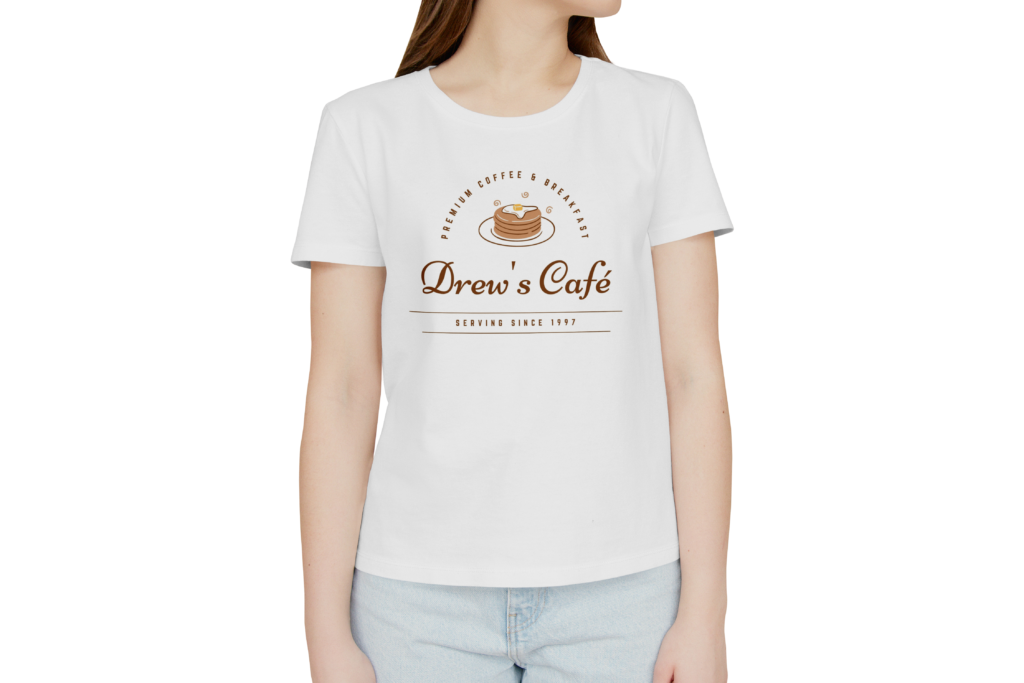 A girl wearing a white 'Premium coffee and breakfast Drew's Cafe Serving since 1977' shirt.