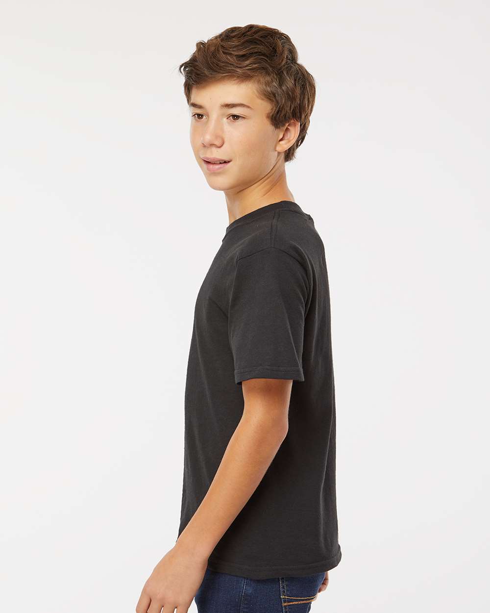 Youth M&O custom black t-shirt modeled standing sideways by boy with curly hair