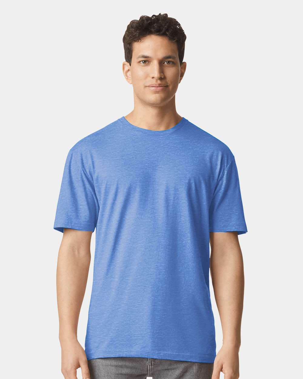 Man wearing a heather royal Gildan softstyle short sleeve t-shirt.