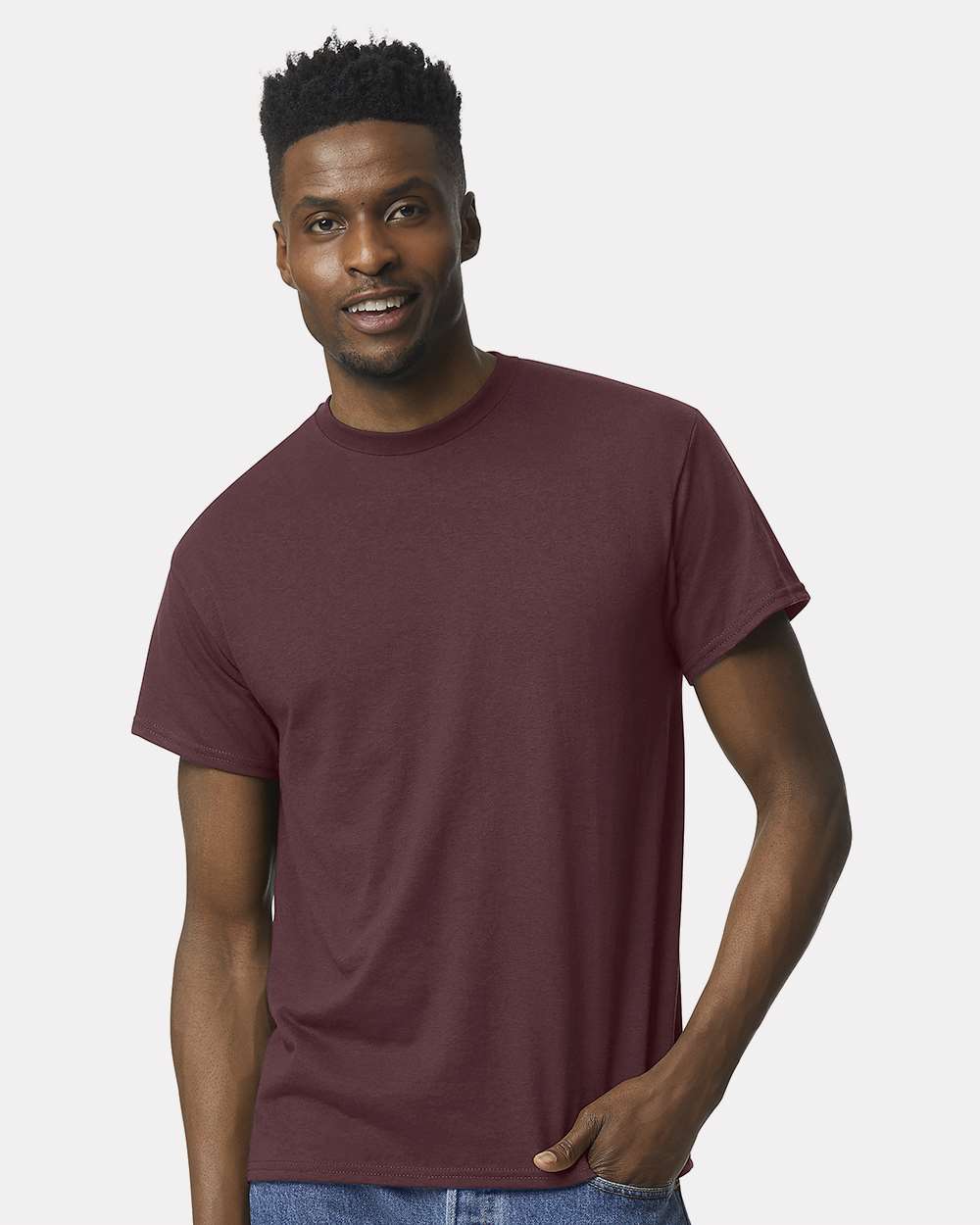 Man wearing a dark maroon Gildan Dryblend 50/50 short sleeve t-shirt.
