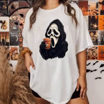Woman wearing a shirt of Ghostface sipping a frappe.