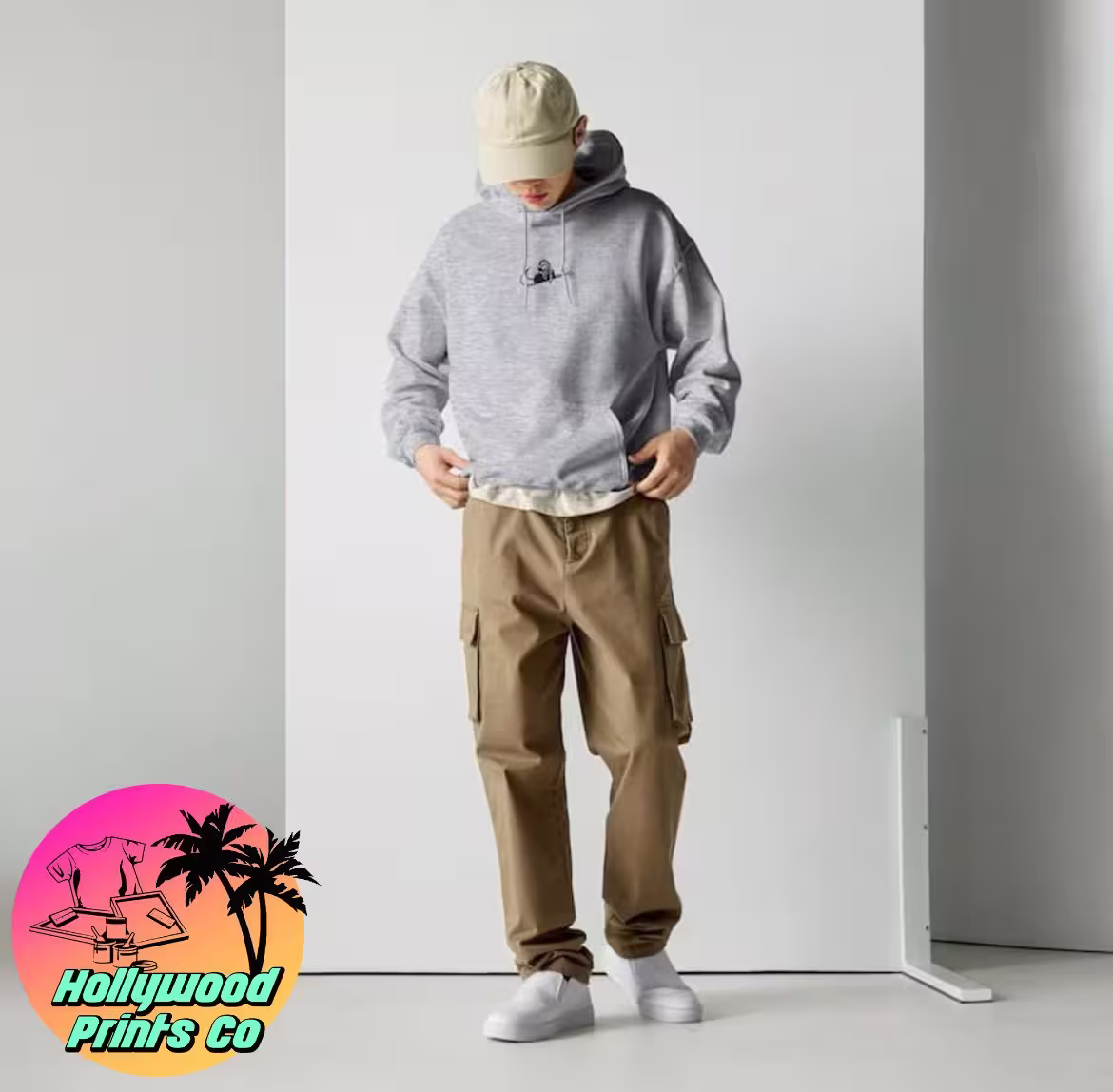 Guy wearing gray spooky season swoosh hoodie