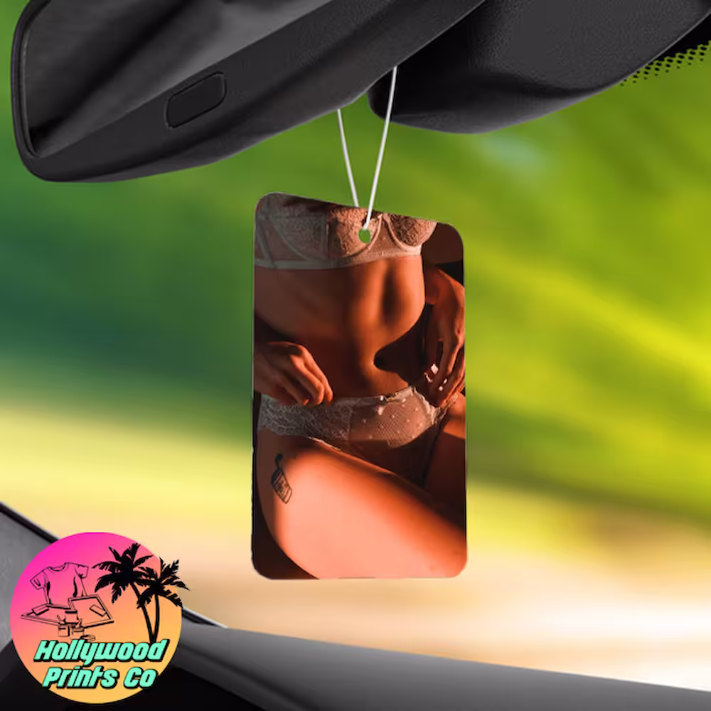 A vibrant photo of a custom air freshener featuring a boudoir photo hanging in a car, showcasing its size and design.