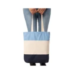 Woman holding Tri-Color Cotton Canvas Tote Bag between legs